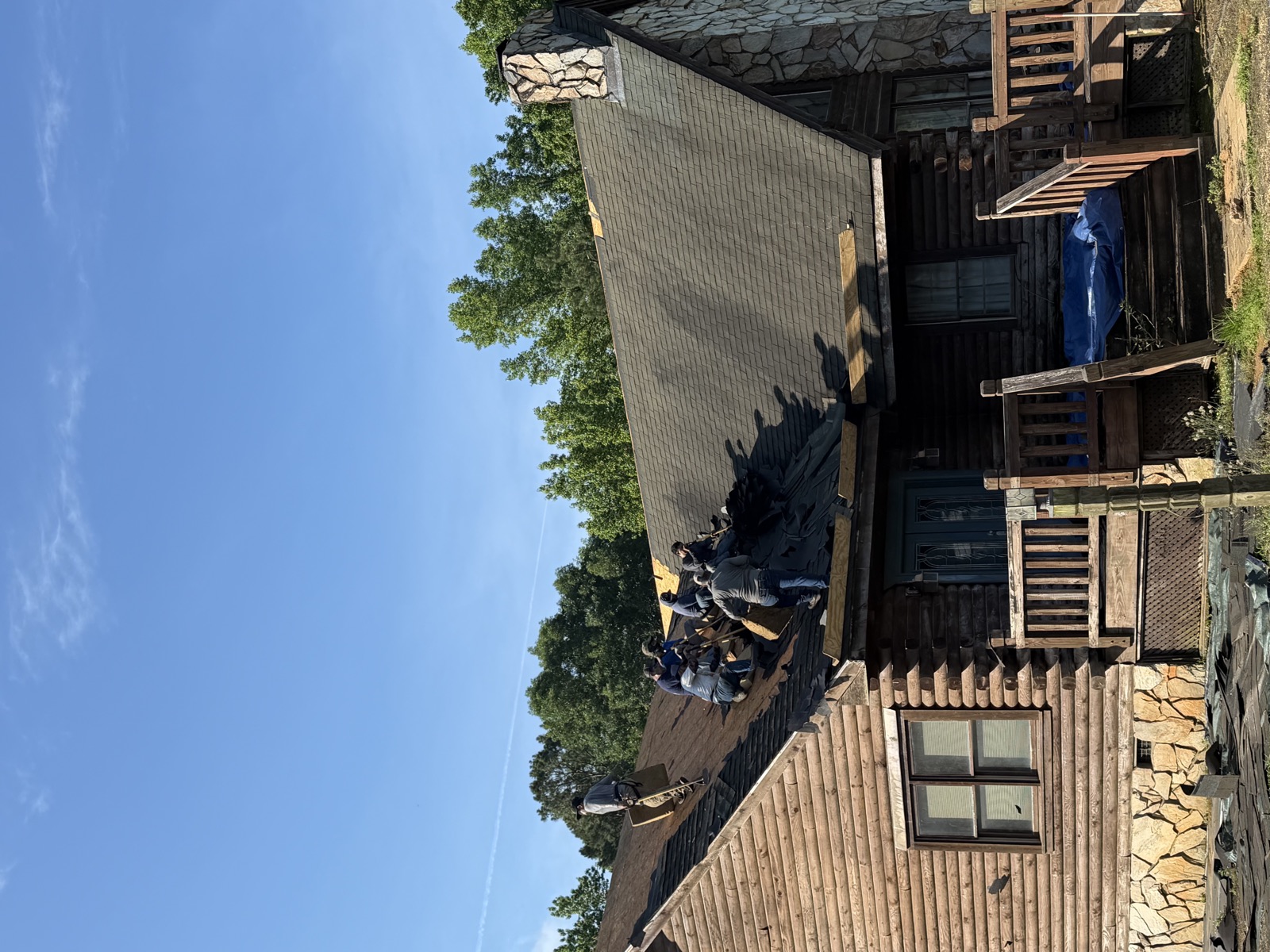 Log cabin roof during tear-off, Serranos crew removing old shingles