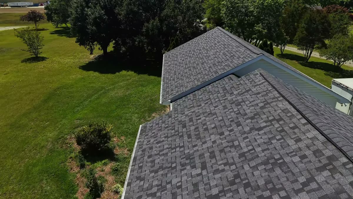 Close drone view of a finished shingle roof by Serranos Contracting