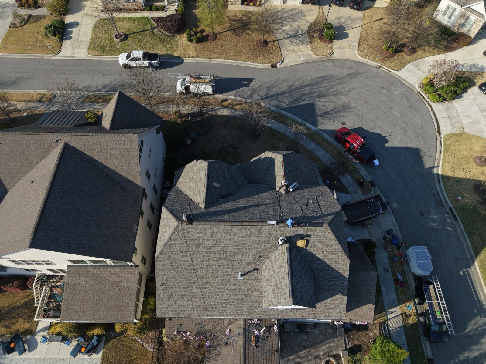 Finished hip roof by Serranos Contracting, drone view of the neighborhood